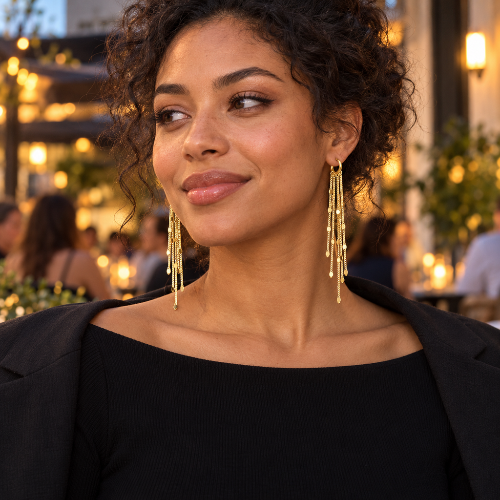 Model wearing gold tone fringe earrings for an evening look